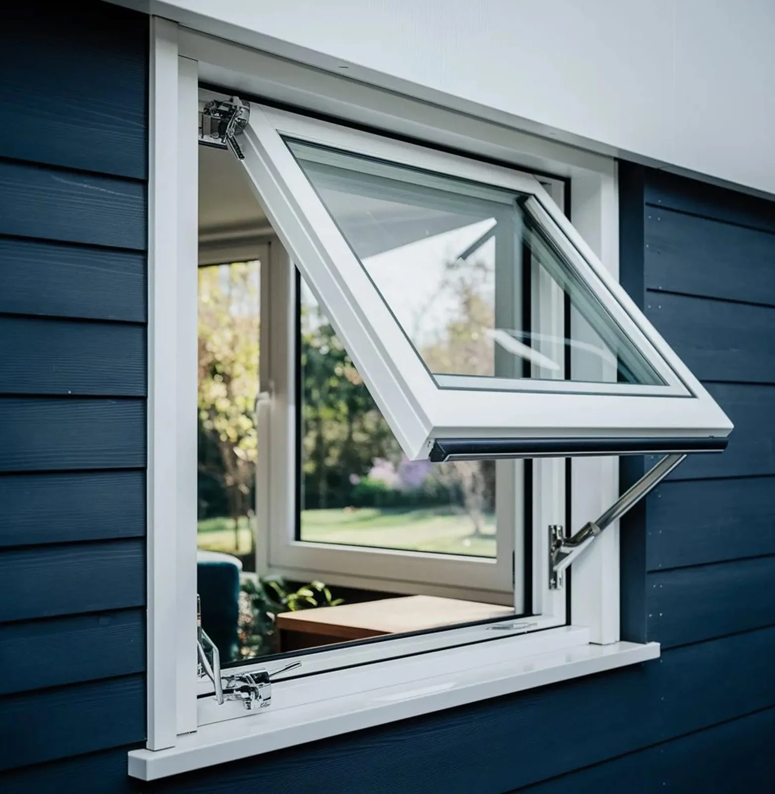 White top-hung window propped open outwards on a dark blue clad wall, garden beyond